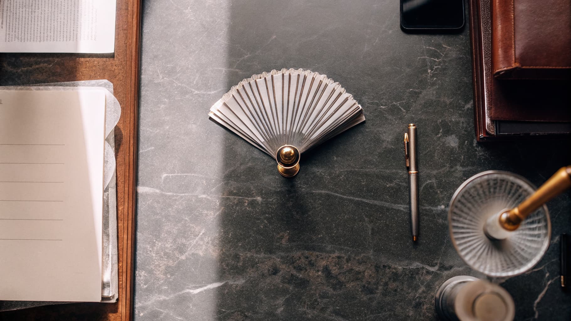 Array of professional legal notary documents on dark marble surface